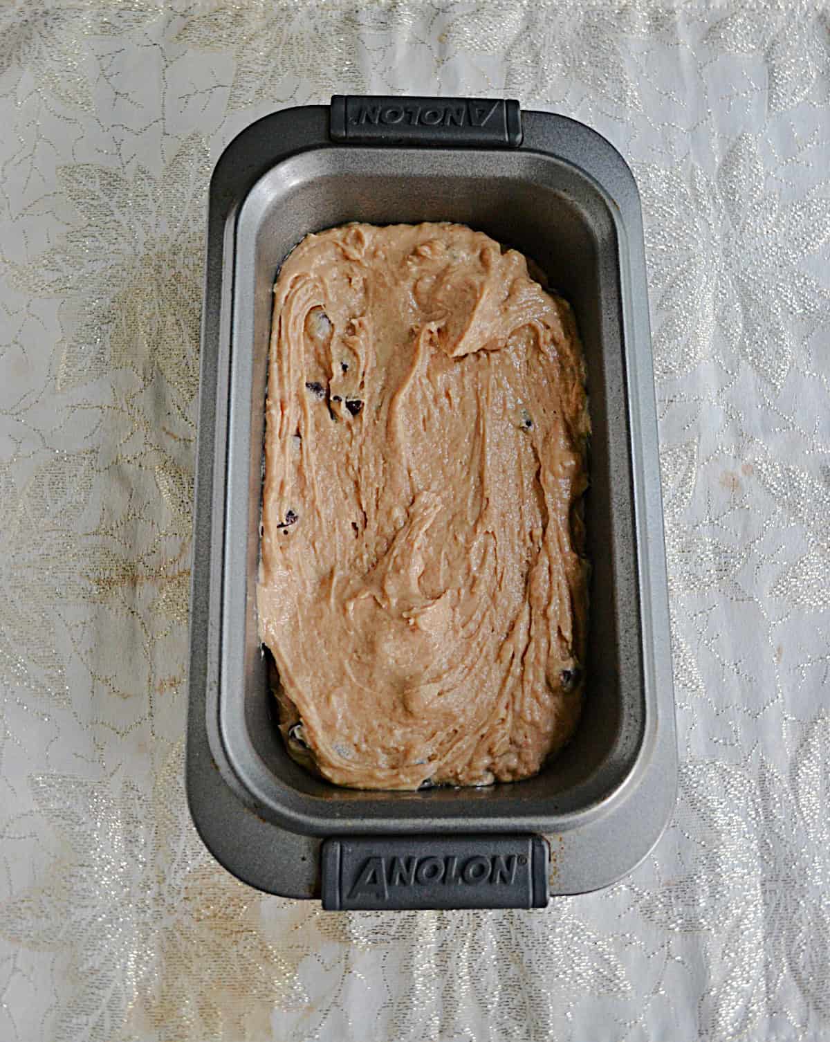 A loaf pan with batter in it.