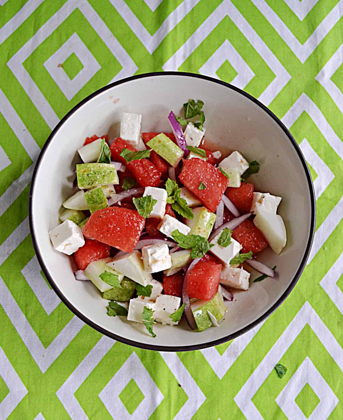 A bowl of watermelon salad with feta and cucumber.