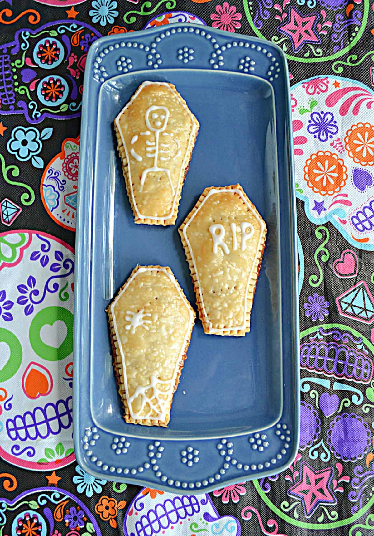 A platter with three golden brown coffin shaped pop tarts.