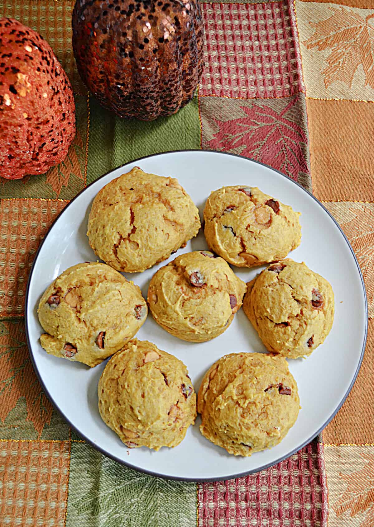 An overhead view of a plate of pumpkin cookies.