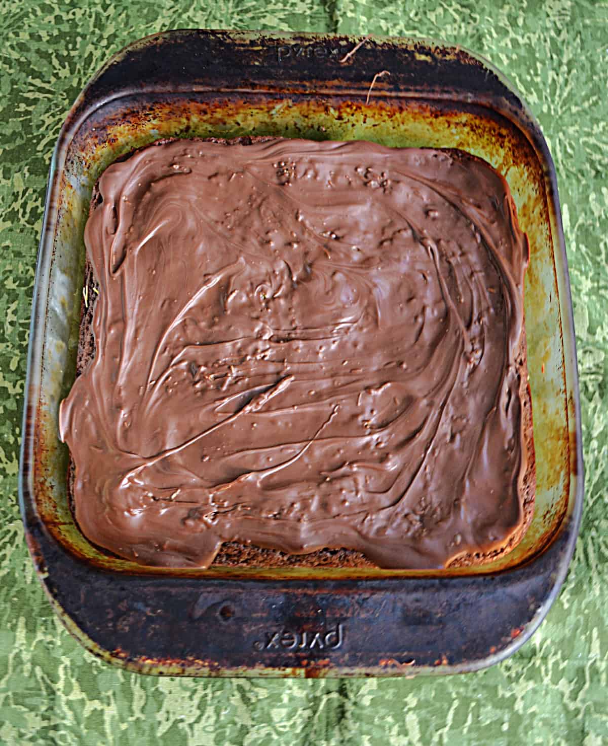 A pan of brownies with chocolate on top.