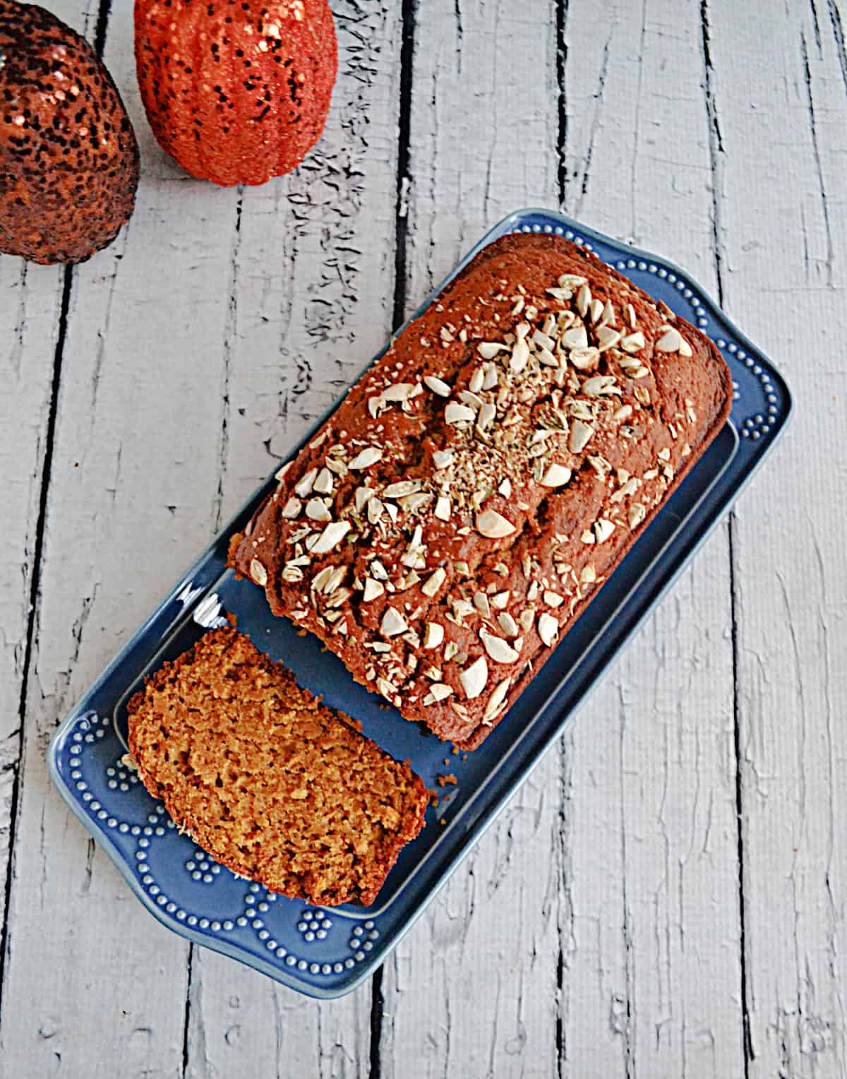 A platter of pumpkin bread with a slice of bread cut off.