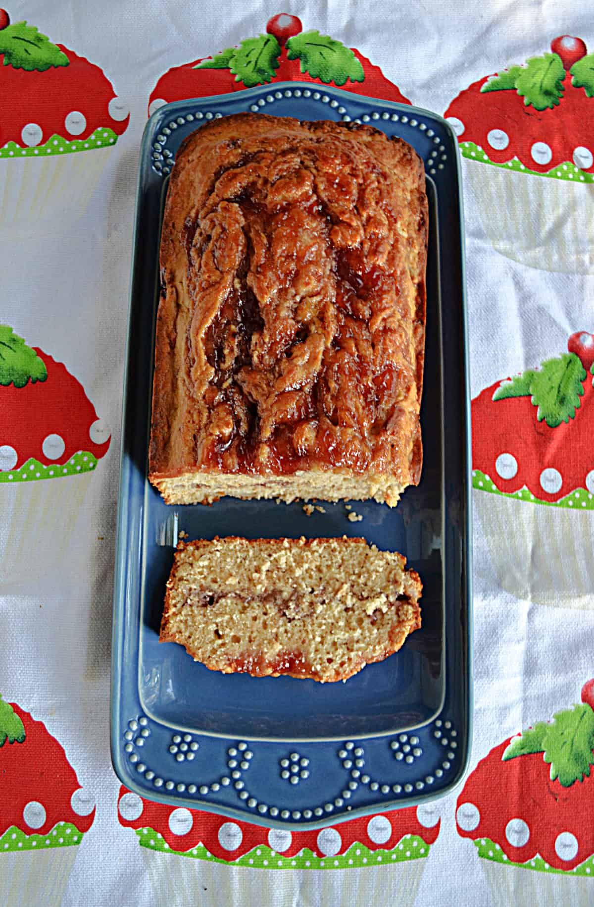 A loaf of bread with a slice cut off on a platter.