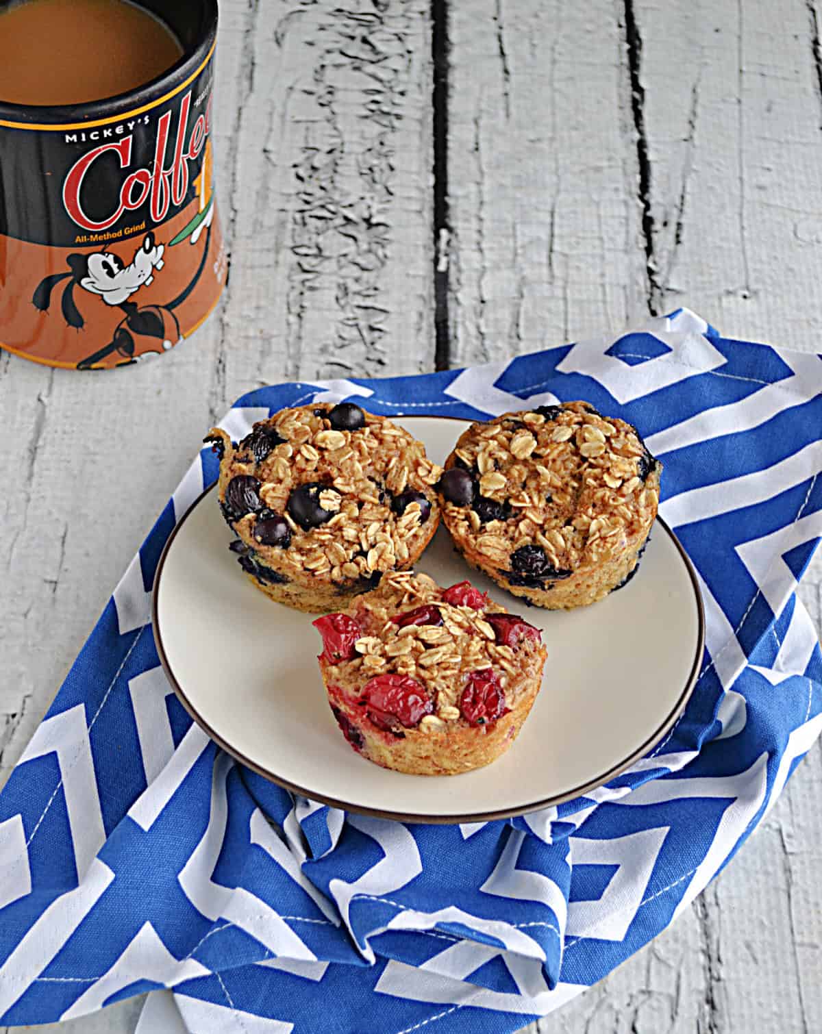 A plate of oatmeal cups with a cup of coffee.