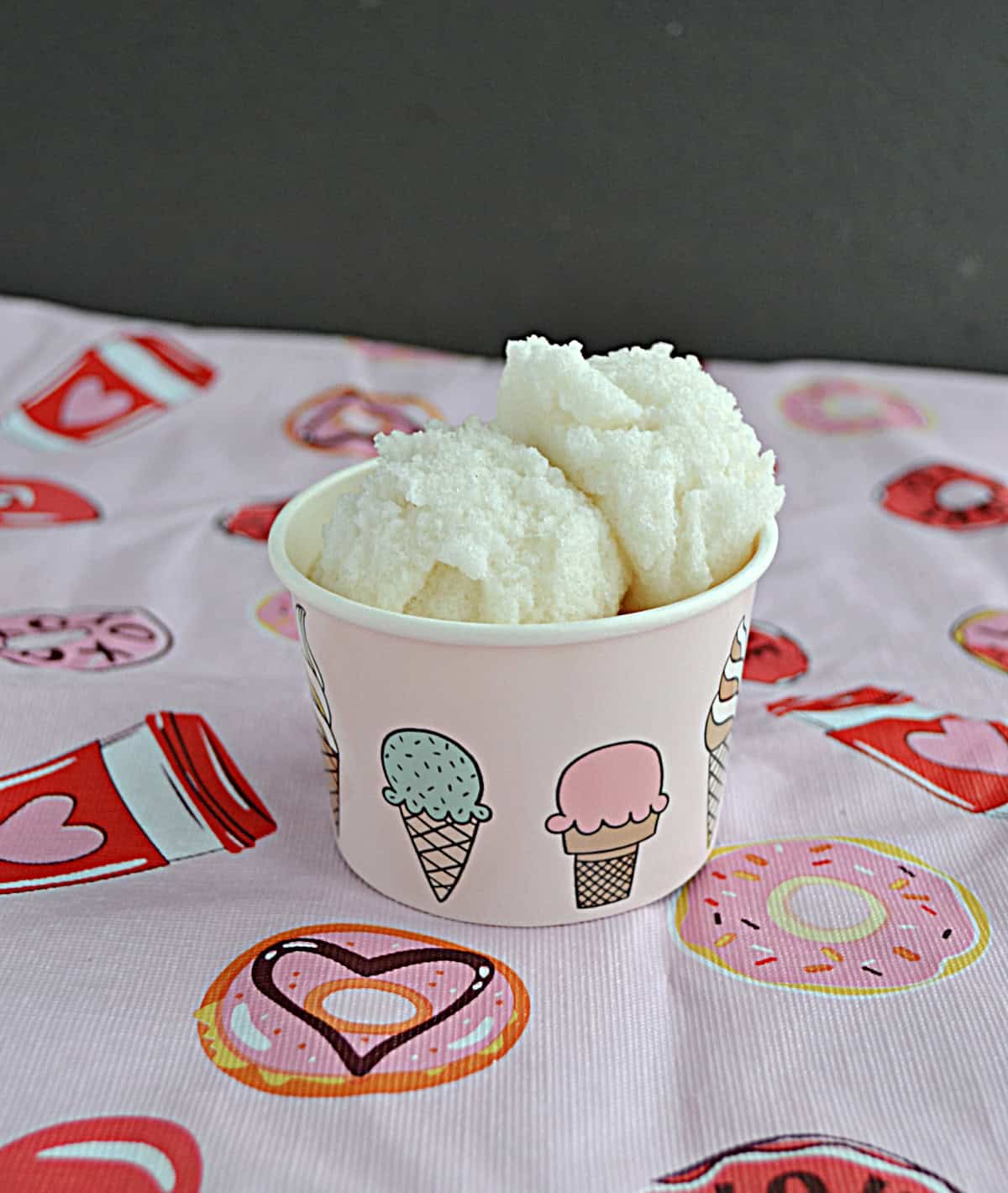 A cup with 2 scoops of ice cream in it.