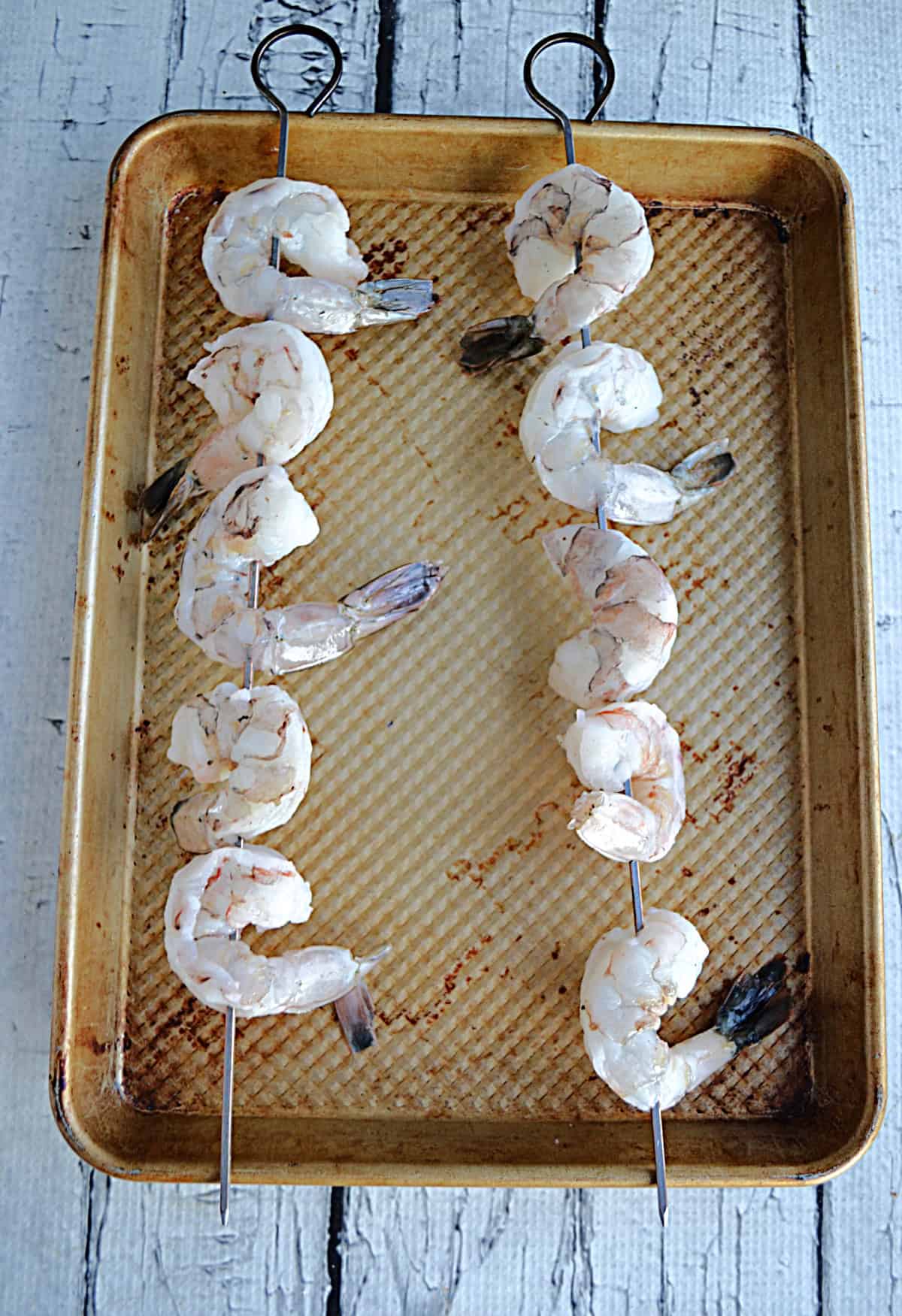 Raw shrimp on skewers.