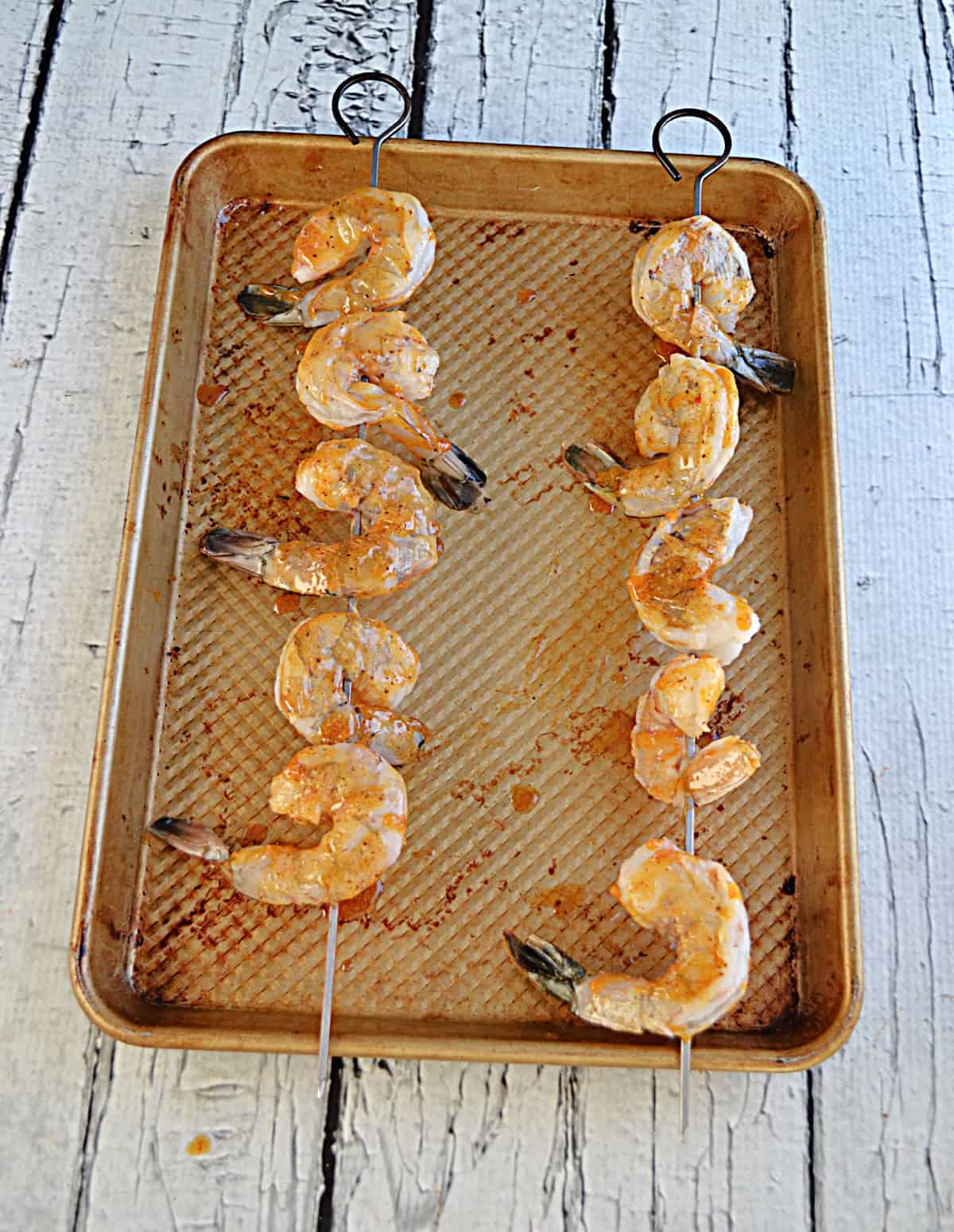 Cooked shrimp on skewers.