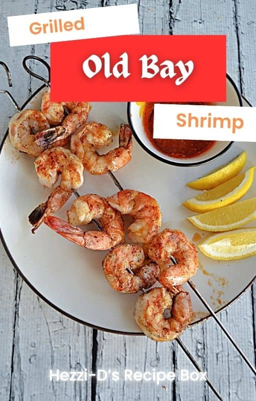 Pin Image: Title, a plate with grilled shrimp skewers, lemon wedges, and a bowl of cocktail sauce.