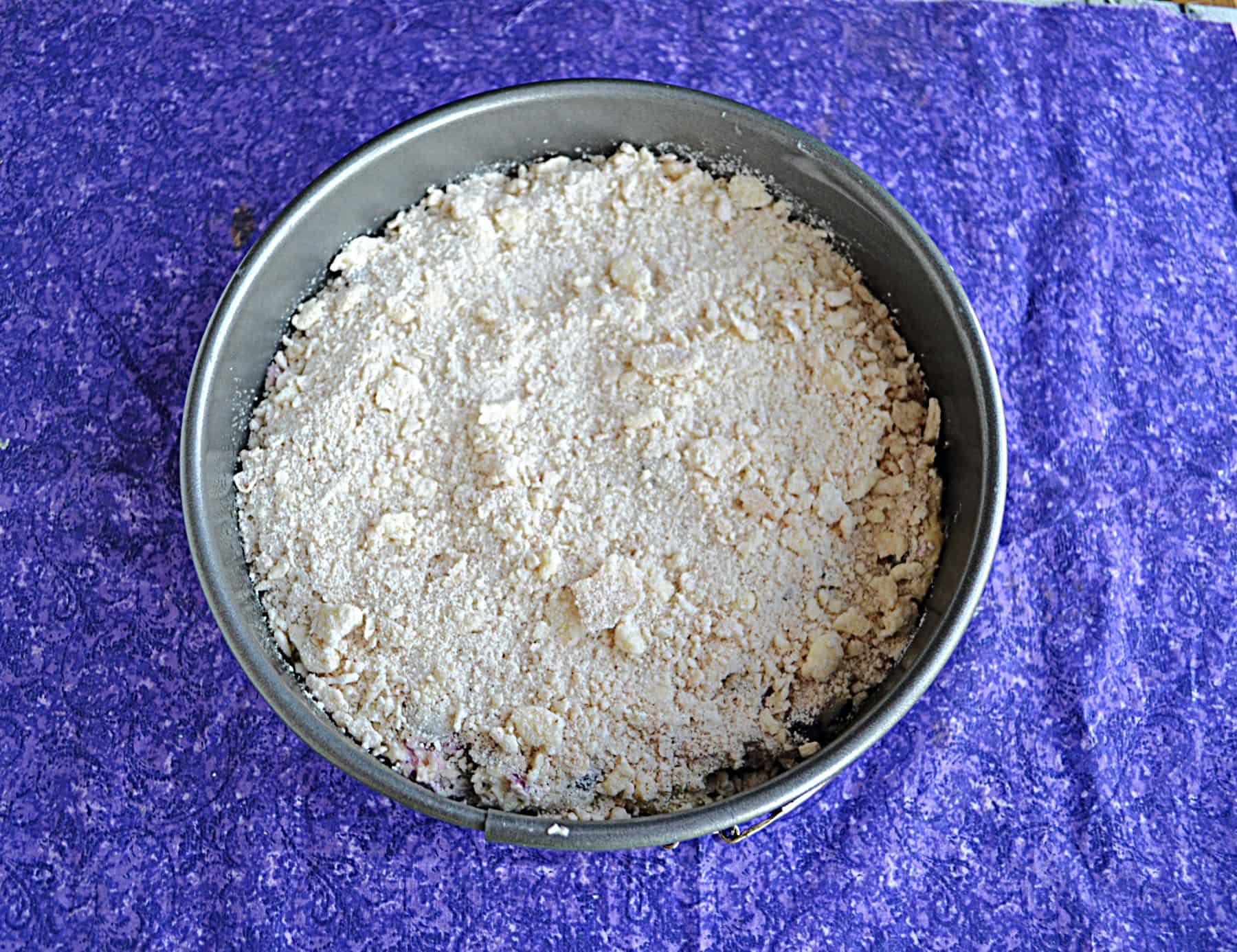 A cake pan with a crumble on top.