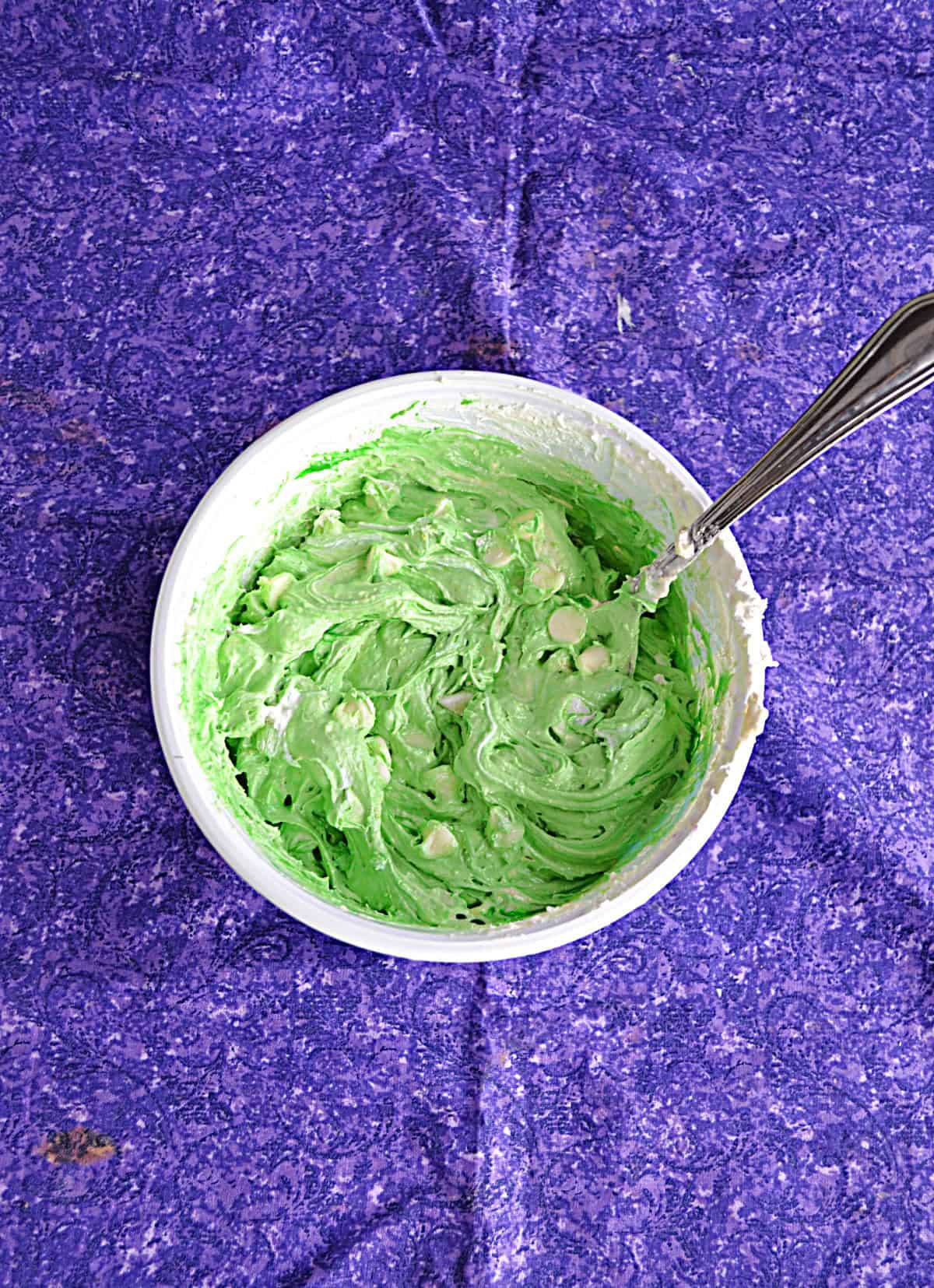 A bowl of green cookie dough.