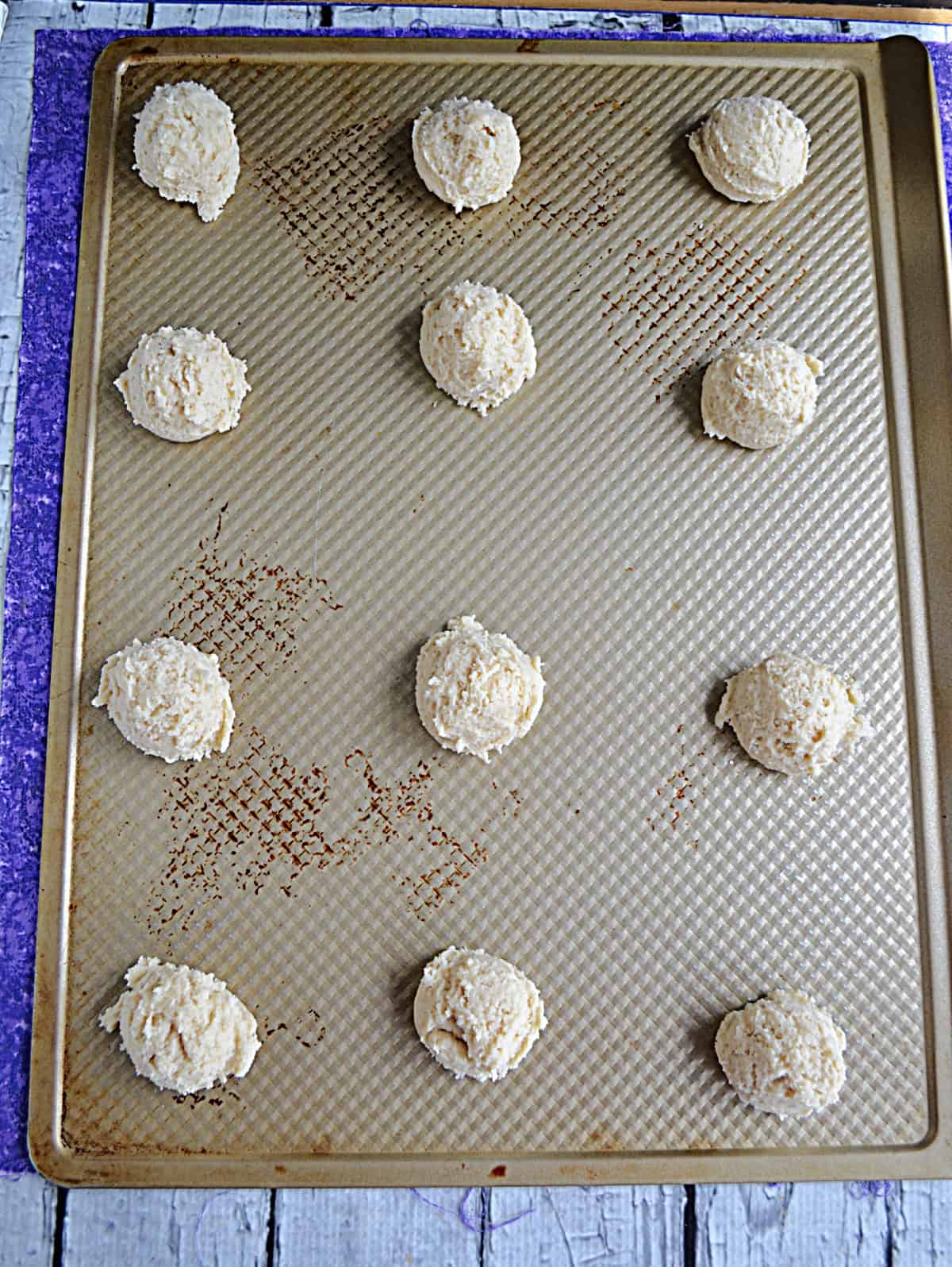 Cookie dough balls on a cookie sheet.