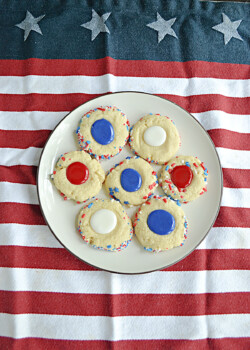 A plate of thumbprint cookies filled with red, white, or blue icing.