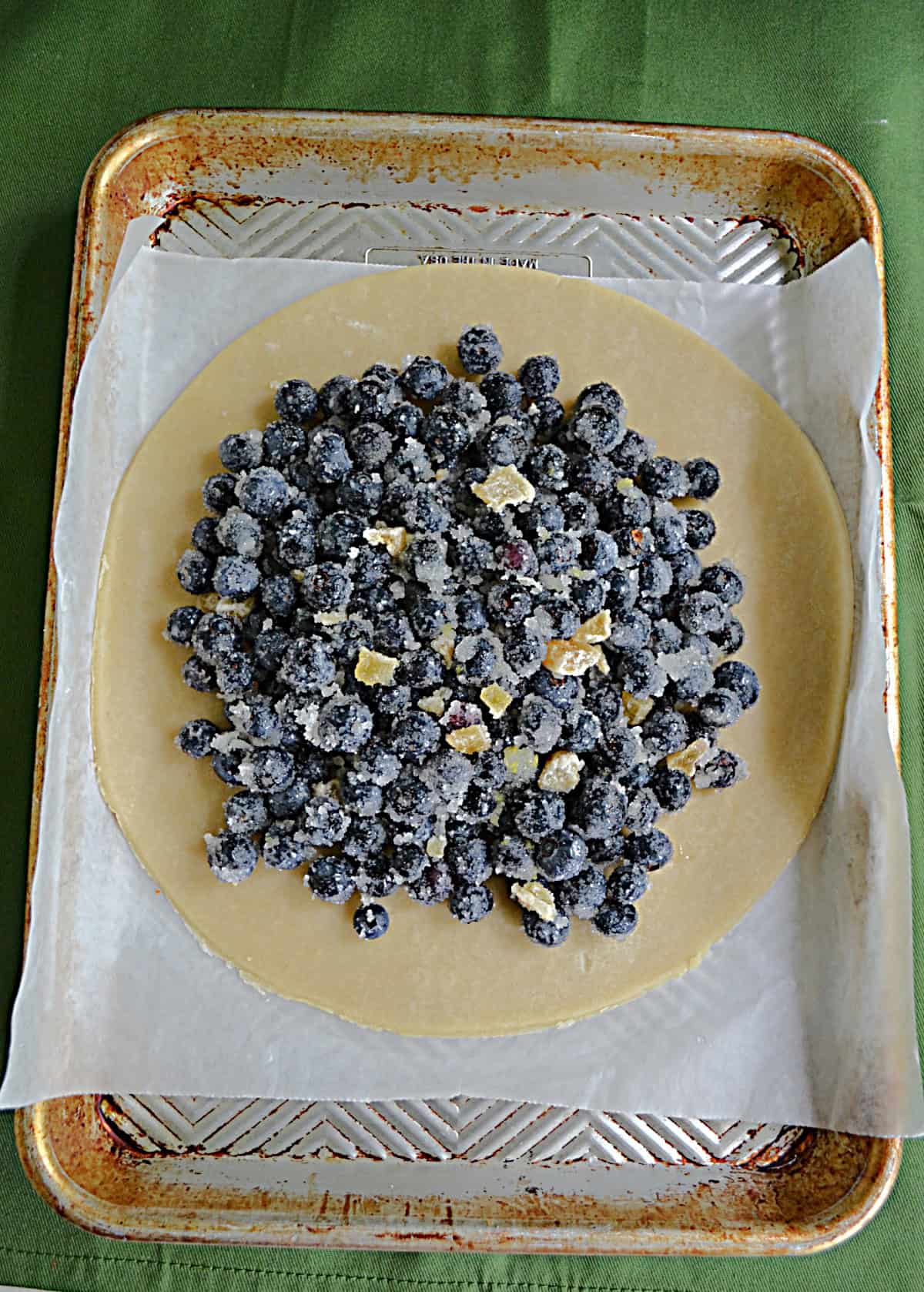 Blueberries in the middle of a dough circle.