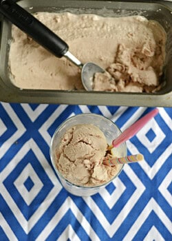 A pan with Copycat Wendy's Frosty in it and a cup with a scoop of the Frosty plus a spoon in it.