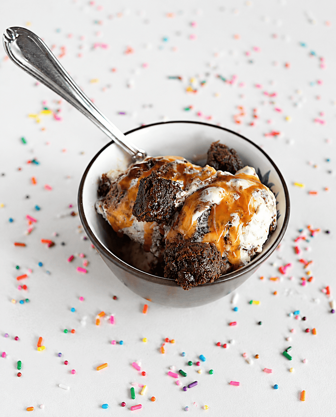 A bowl of ice cream with a spoon in it.