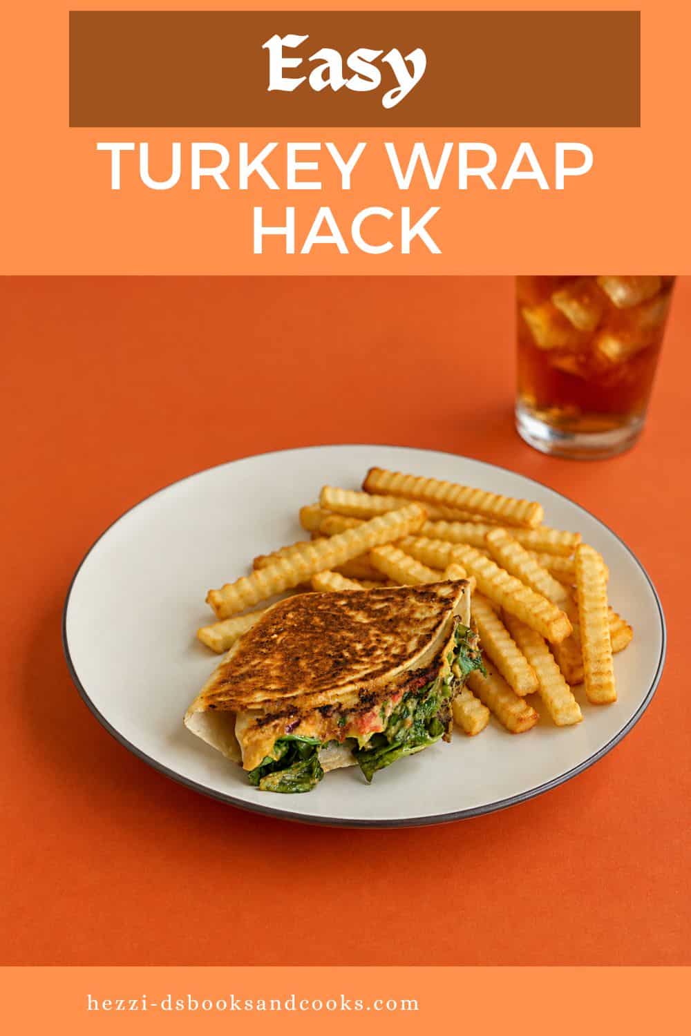 Pin Image: Title, A plate with a golden brown wrap on it along with fries and a glass of tea behind the glass.